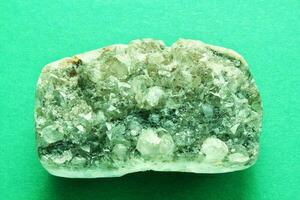 Natural green beryl druse geode mineral crystal unpolished semi-precious gemstone. Magic rock for ritual, witchcraft, spiritual practice, meditation. Esoteric life balance concept. Copy space photo
