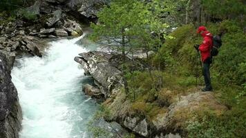 Hiker on the Rocky Mountain River Shore in Slow Motion video