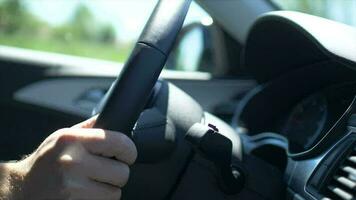 Hand on the Car Steering Wheel While Driving. Closeup Video