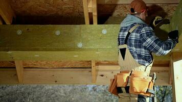 House Insulating. Contractor Worker Attaching Blocks of Insulation Mineral Wool. video