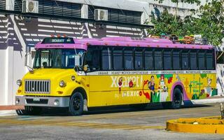 Playa del Carmen Quintana Roo Mexico 2023 Colorful pink yellow green Xcaret bus Playa del Carmen Mexico. photo