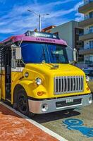 Playa del Carmen Quintana Roo Mexico 2023 Colorful pink yellow green Xcaret bus Playa del Carmen Mexico. photo