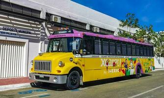 Playa del Carmen Quintana Roo Mexico 2023 Colorful pink yellow green Xcaret bus Playa del Carmen Mexico. photo