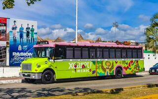 Playa del Carmen Quintana Roo Mexico 2023 Colorful pink yellow green Xcaret bus Playa del Carmen Mexico. photo