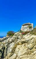 Puerto Escondido Oaxaca Mexico 2023 Hotel Condos Apartments on rocky cliff by sea and nature. photo