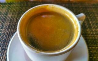 Cup of americano black coffee in restaurant Mexico. photo