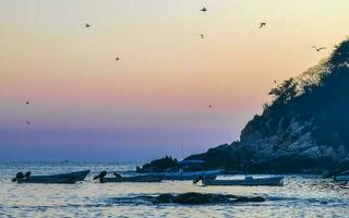 Colorful golden sunset big wave and beach Puerto Escondido Mexico. photo