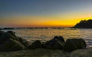 Colorful golden sunset big wave and beach Puerto Escondido Mexico. photo