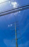 Huge gigantic power pole and cable blue sky clouds Mexico. photo