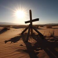 Wooden cross stands in desserts with sunlight photo