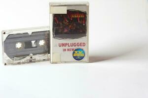 Bangkok, Thailand - 05 October 2021  Nirvana's 90s cassette tape Unplugged in new york on a white background. photo