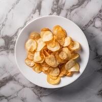 Delicious potato chips in a deep white plate photo