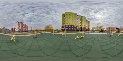 360 hdri panorama view outdoor exercise equipment gym among modern residential complex with skyscrapers and high-rise buildings in equirectangular spherical projection ready VR virtual reality content photo