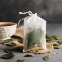 Teabag with delicate leaves photo