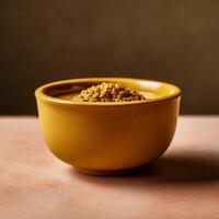 Close up of mustard in bowl on beige background photo