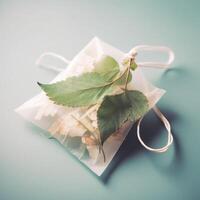 Teabag with delicate leaves photo