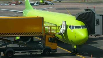 MOSCOW, RUSSIAN FEDERATION JULY 24, 2021 - Boeing 737 of S7 airlines boarding passengers at Domodedovo airport, Moscow DME. Food delivery on board, catering video