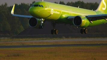 NOVOSIBIRSK, RUSSIAN FEDERATION JUNE 17, 2020 - The S7 Airlines plane landing at sunset at Tolmachevo Airport, Novosibirsk. Airbus A320 airline S7 arrival at sunset video