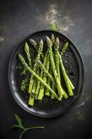 Traditionally grilled green asparagus with herbs as a top view on a modern design plate with copy space, generate ai photo
