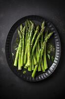 Traditionally grilled green asparagus with herbs as a top view on a modern design plate with copy space, generate ai photo