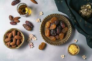 Eid al-Fitr holiday concept with sweet dried dates, fruits and decorations on bright background. Top view from above, generate ai photo