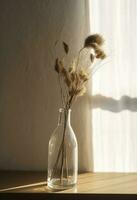 Dried meadow grass bouquet in clear glass bottle aesthetic sun light shadows on neutral wall, minimalist floral interior design , generate ai photo