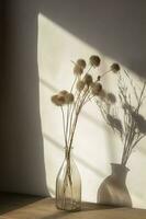 Dried meadow grass bouquet in clear glass bottle aesthetic sun light shadows on neutral wall, minimalist floral interior design , generate ai photo