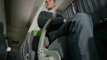 Caucasian Male Passenger Looking Around While Sitting In Armchair Of Small Empty Bus. video