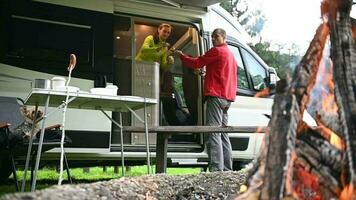 Caucasian Couple, Their Dog and RV Motorhome During Camping Getaway video