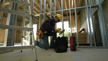 Construction Contractor Looking For Tools Inside His Bag. video