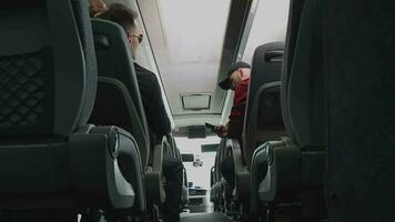 Male Passengers Sitting On Bus Talking To Each Other Adjusting Seats And Checking Cell Phone. video