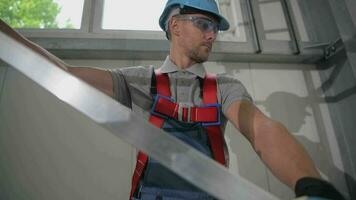 Male Construction Worker Setting Up And Adjusting Metal Scaffold Structure Inside Of Commercial  Building video