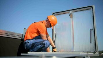 Caucasian Technician Assembling Roof Entrance on Building Roof video