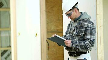 Caucasian Foreman Makes Notes And Checks Progress On Job Site. video