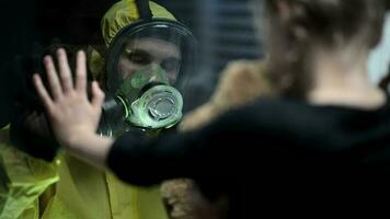 Man In Protective Suit Saying Goodby To Daughter Through Glass Window. video