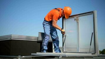 Worker Assembling Roof Entrance on Building Roof video