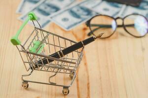 online business concept fountain pen in shopping cart. photo