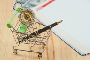 online business concept fountain pen in shopping cart. photo