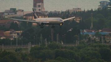 SOCHI, RUSSIA JULY 30, 2022 - Widebody airplane Boeing 777 of Aeroflot landing at sunset. Cinematic shot of passenger airliner flies, arrival. Tourism and travel concept video