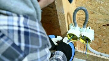 Male Construction Worker Arranges Electric Wires In Newly Installe Outlet. video