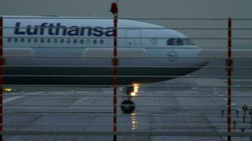 DUSSELDORF, GERMANY JULY 24, 2017 - Lufthansa Airbus 330 D AIKG taxiing after landing at rain early morning. Dusseldorf airport, Germany video