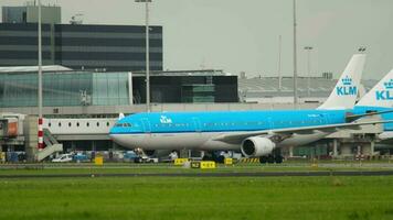 AMSTERDAM, THE NETHERLANDS JULY 27, 2017 - Civil Airbus A330 303, PH AKB of KLM taxiing at runway Schiphol Airport, Amsterdam AMS. KLM airplanes at the airport, traffic video