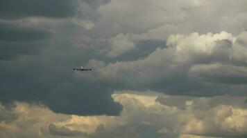 Rear view, airliner flying away. Jet airplane take off, climb in the dark stormy sky video