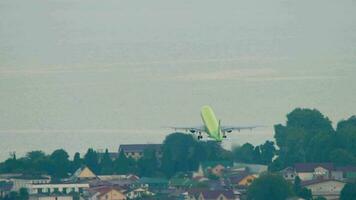 SOCHI, RUSSIA JULY 30, 2022 - Commercial airplane of S7 Airlines takeoff and climb at Sochi airport. Tourism and travel concept video