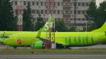 NOVOSIBIRSK, RUSSIAN FEDERATION JUNE 10, 2020 - Boeing 737 of S7 Airlines taxiing at Tolmachevo airport. Airliner rides to the terminal, arrival. video