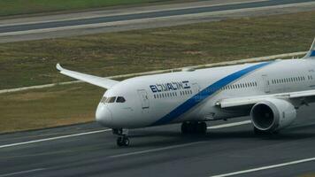 PHUKET, THAILAND FEBRUARY 03, 2023 - Boeing 787 of El Al taxiing at Phuket Airport. Airplane arriving, side view. Passenger jet plane on the taxiway. Tourism and travel concept video