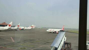 Tangerang, Indonesia in May 2023. Several aircraft, namely Air Asia, Lion Air and several other aircraft on the apron and runway of Terminal 2 of Soekarno Hatta Airport. video