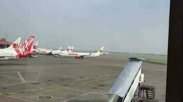 Tangerang, Indonesia in May 2023. Several aircraft, namely Air Asia, Lion Air and several other aircraft on the apron and runway of Terminal 2 of Soekarno Hatta Airport. video