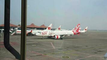 Tangerang, Indonesia in May 2023. Several aircraft, namely Air Asia, Lion Air and several other aircraft on the apron and runway of Terminal 2 of Soekarno Hatta Airport. video