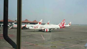 Tangerang, Indonesia in May 2023. Several aircraft, namely Air Asia, Lion Air and several other aircraft on the apron and runway of Terminal 2 of Soekarno Hatta Airport. video